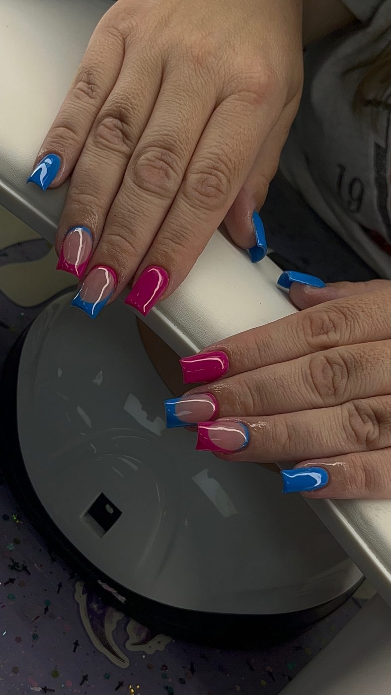 Lia nail art with hot pink and electric blue color-blocked nails.