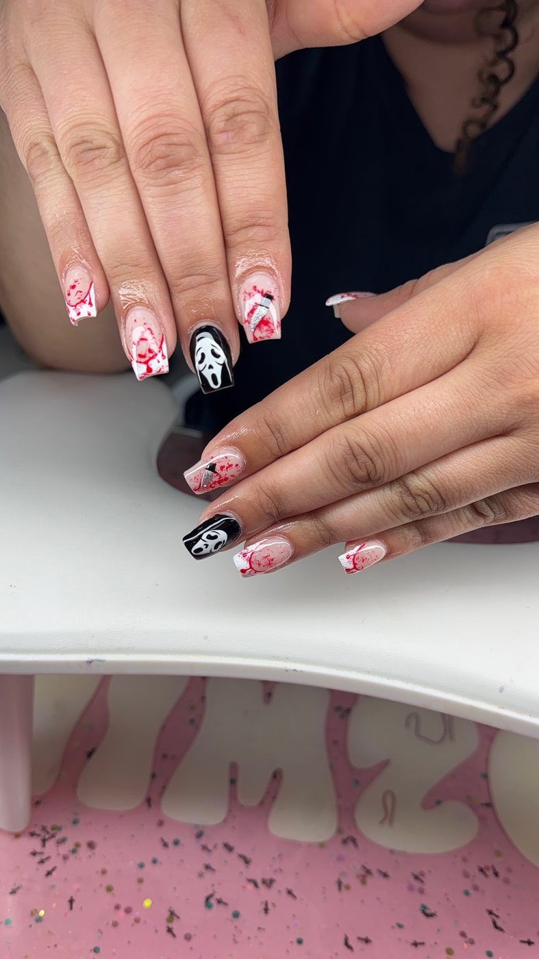 Serenity nail art with a black-and-white horror accent nail and red splatter details.